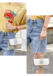 Detailed view of women crossbody square bag with grey white patchwork and gold metal clasp