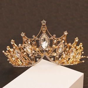 Macro shot of Baroque golden crown featuring marquise crystals and fine pearl beads