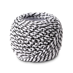 Close-up of black and white 3-strand twisted cotton cord roll for DIY crafts and gift wrap