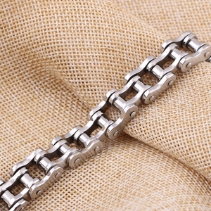 Detail of 12mm stainless steel bicycle chain bracelet on a rustic linen background