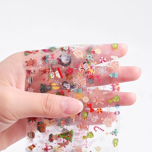 Detailed view of transparent Christmas nail art transfer stickers with festive patterns