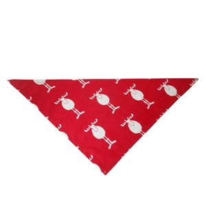 Detail of red Christmas pet bandana with white reindeer pattern and fine cotton texture