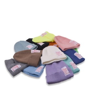 Colorful knitted beanies for kids with vintage label in various vibrant candy colors
