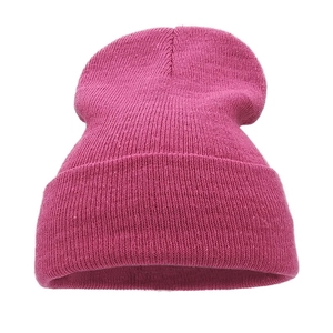 Close-up of pink knitted winter beanie showing soft texture and folded cuff detail