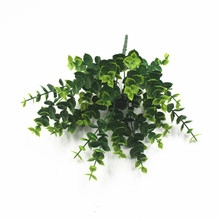 Close-up of artificial eucalyptus hanging vines with detailed green leaves on white background