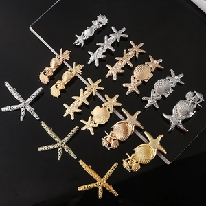 Elegant gold and silver ocean starfish hair clips set with sea shell and pearl accents