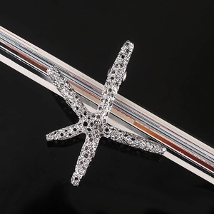 Detail view of silver starfish hair clip with nautical texture and metal clasp