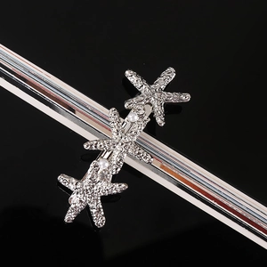 Detail of silver starfish hair clip with white pearls and sparkling rhinestones