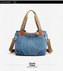 Detailed front view of navy canvas tote bag with contrast stitching and web handles