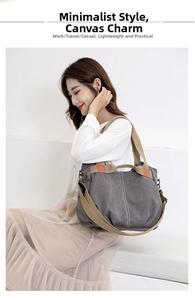 Detail of dark grey canvas tote bag with thick khaki strap and orange contrast accents