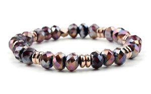 Macro shot of faceted purple amethyst beads with rose gold metal spacers on a bracelet