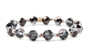 Macro shot of faceted smoky amethyst beads with rose gold accents on a beaded bracelet