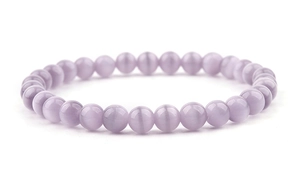 Detailed macro view of high-quality light purple amethyst beads on an elastic bracelet