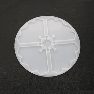 Macro view of a 4-grid circular silicone resin mold with decorative scalloped edges
