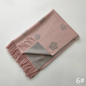 Detail of pink and grey camellia jacquard scarf showing soft texture and tassel fringes