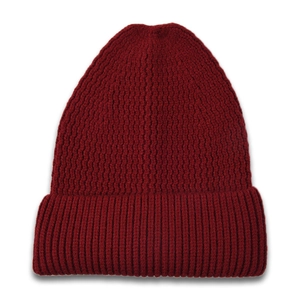 Detailed texture of thick burgundy ribbed knit beanie showing vertical wavy patterns