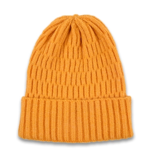 Detail of ribbed knit texture on a bright orange winter beanie with folded cuff