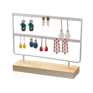Dual-tier white metal earring display stand with a solid wooden base for jewelry storage