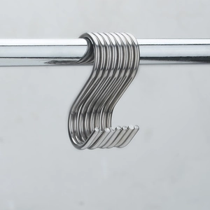 Polished S-shaped stainless steel hooks hanging on a metal rod for kitchen storage