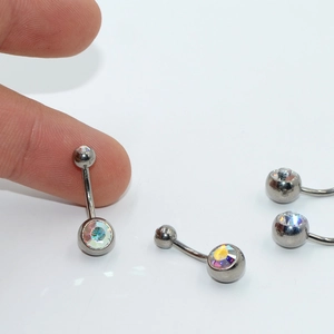 G23 titanium belly button ring set with colorful rainbow crystals in a macro studio view
