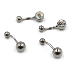 Macro view of four G23 titanium belly rings with sparkling rhinestones on white backdrop