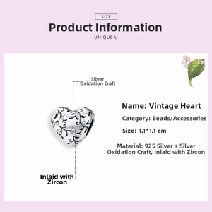 Macro detail of S925 sterling silver heart bead with vintage floral engraving and zircons