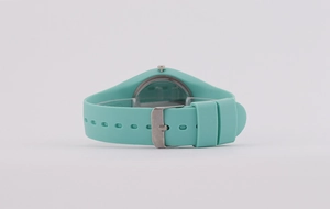 Detail view of teal silicone strap and metallic buckle on a stylish quartz watch