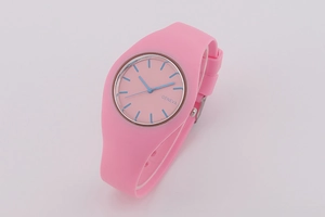 Detailed macro view of the pink silicone strap and round dial with blue needles