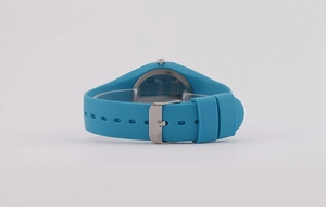 Detail of blue silicone watch strap and silver metal buckle on a minimalist timepiece