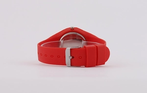 Detailed view of adjustable red silicone watch strap with secure metal buckle closure