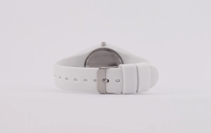 Detail view of white silicone strap and silver metal buckle of women's quartz watch