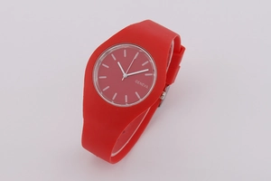 Detailed close-up of a vibrant red Geneva silicone watch with minimalist analog dial