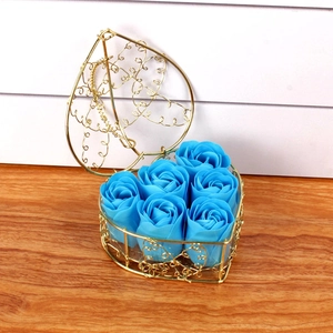 Detail of 6 blue soap roses in a heart-shaped gold metal wire basket for gift decor