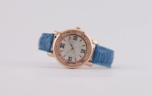 Close-up of blue crocodile leather strap and rose gold watch case with Roman numerals