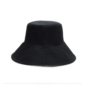 Detail view of the back of a black canvas sun hat with a wide brim and fine texture