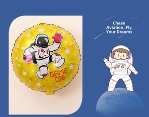 Close-up of yellow round foil balloon with astronaut cartoon and Game On text print