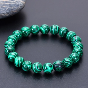 Natural malachite beaded bracelet with unique green and black banded patterns on stone