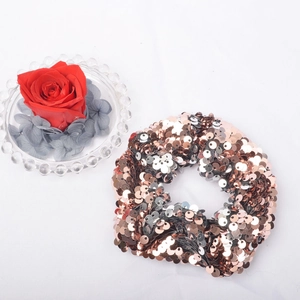 Detail of two-tone mermaid sequins hair scrunchie in rose gold and silver metallic finish