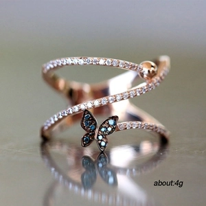 Rose gold butterfly ring with blue zircon and micro-pave crystals on multi-layer band