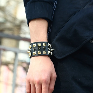 Men's punk faux leather wristband with triple rows of gold cone studs and rivets