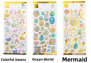 Macro detail of holographic stickers with gold foil edges in swan and mermaid themes