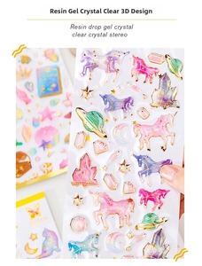 Detailed macro view of 3D crystal resin stickers with unicorn and galaxy gold foil motifs