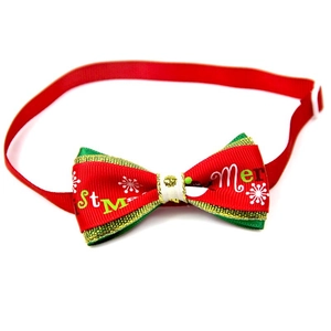 Detail of red and green Christmas pet bow tie with snowflake print and adjustable strap