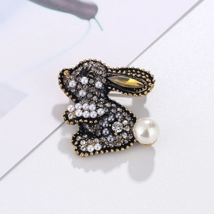 Golden rabbit brooch with grey rhinestones, white pearls and amber gemstone inlay