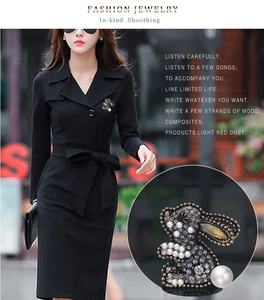 Detail of bunny brooch with dark rhinestones and a white pearl on black lapel