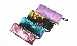 Row of four reversible sequin mermaid pouches in pink, cyan, black-gold, and purple