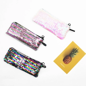 Three sequin pencil cases in pink, silver, and rainbow colors on a white background