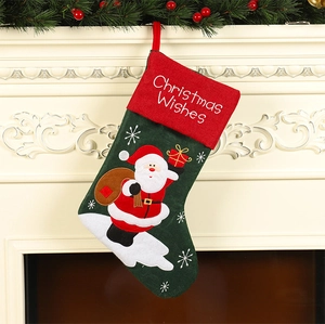 Classic red and green embroidered Christmas stocking with Santa Claus motif on a mantel