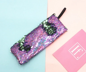 Detail of reversible purple and green sequins on rectangle pencil case with zipper