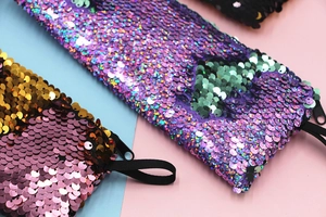 Macro detail of mermaid sequins and durable zipper on stylish stationery storage bags